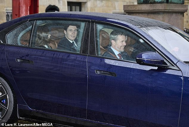 Business as usual: Frederik is seen driving with his son Prince Christian and wife Prince Mary so the young Prince can sign the Constitution