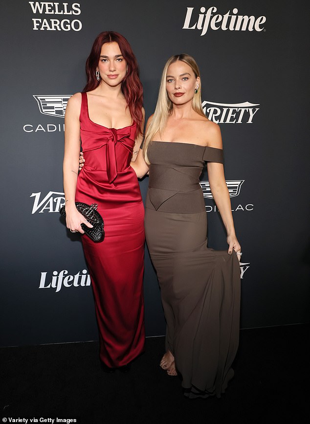 Margot Robie and Dua Lipa caught up on the red carpet as the posed for photos at the glitzy event