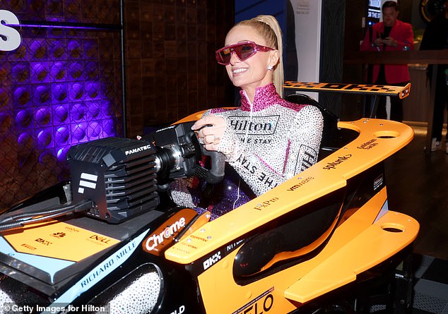 Paris Hilton donned a sparkly race suit as she mucked in and jumped into a McLaren race simulator
