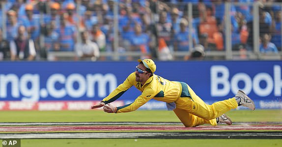 Australia's Travis Head catches to get India's captain Rohit Sharma out during the ICC Men's Cricket World Cup final match between Australia and India in Ahmedabad, India, Sunday, Nov. 19, 2023. (AP Photo/Rafiq Maqbool)