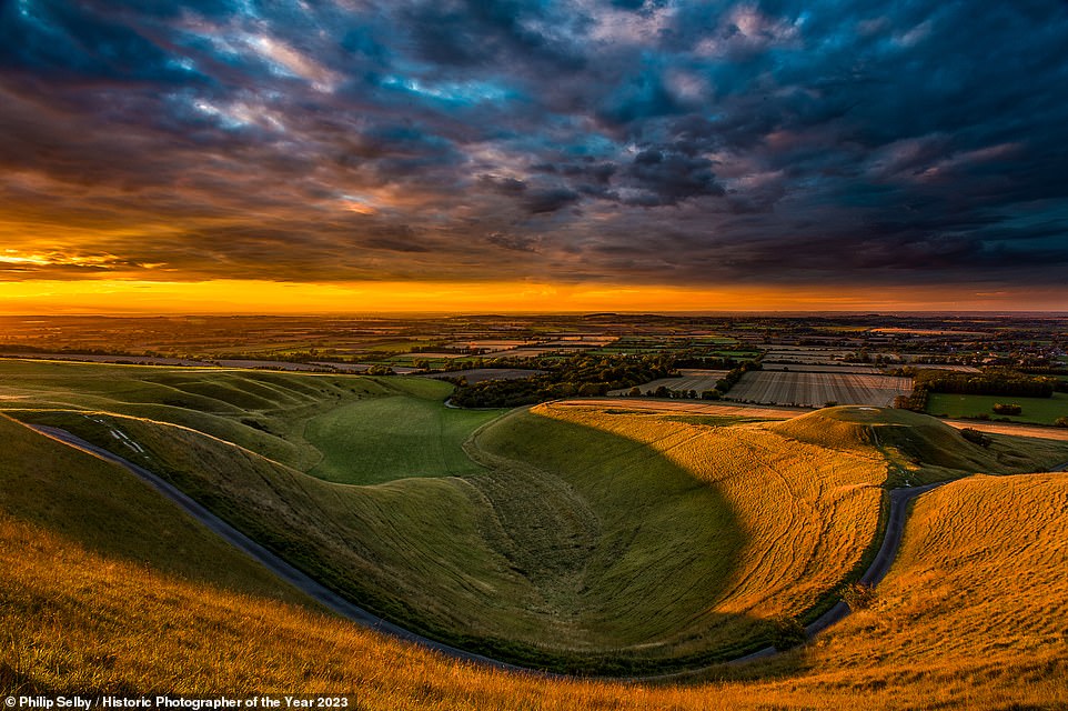 Here, the undulating slopes of Uffington White Horse and Dragon Hill are captured under a thick blanket of cloud, separated by a warm, orange horizon. Philip Selby captured the image, which garners a place on the Historic England Shortlist and the Overall Shortlist