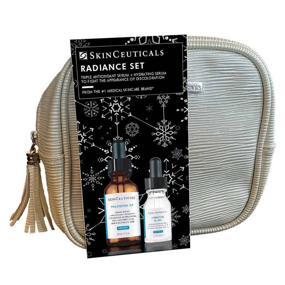 SkinCeuticals Holiday Radiance Set, goldene Tasche mit Quaste auf weißem Hintergrund