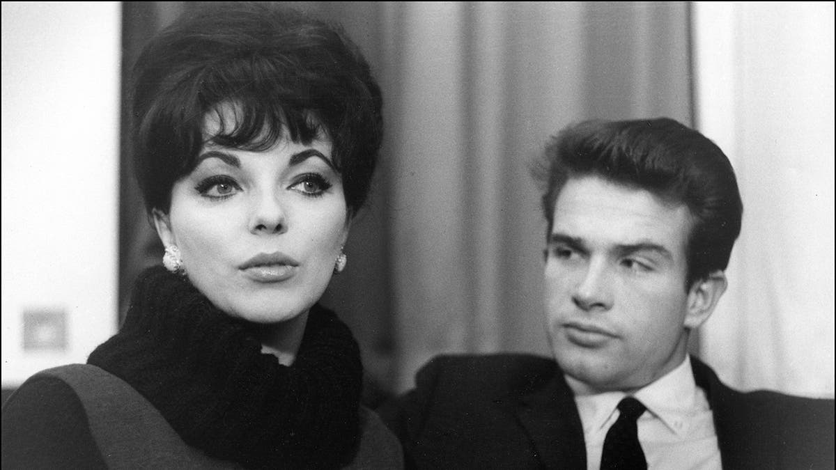 Warren Beatty blickt auf einem Schwarz-Weiß-Foto von ihnen streng auf Joan Collins