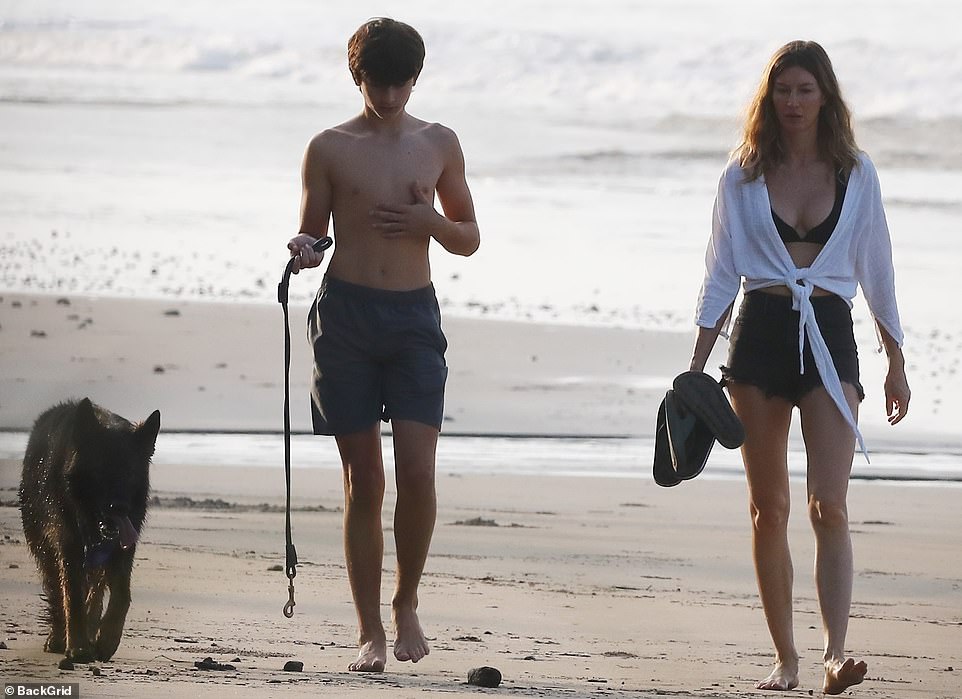 Covering up: The supermodel donned a white shirt while spending time by the water