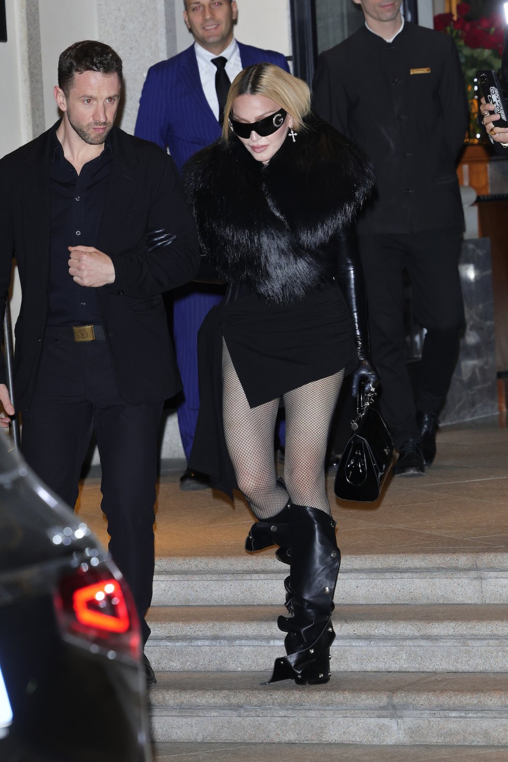 Madonna tritt nach der Celebration-Tour-Show in Mailand in Netzstrumpfhosen und lässigen Stiefeln auf