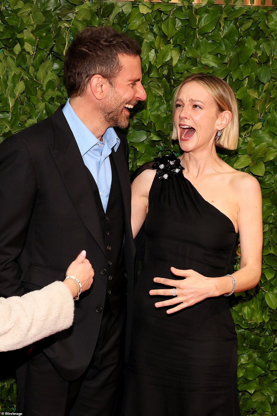 Funny: The father-of-one made Mulligan laugh as he cracked a joke to her on the red carpet