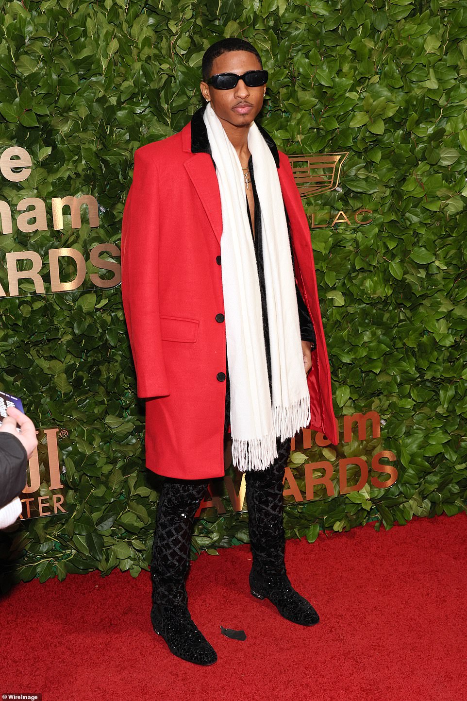 Myles Frost wore an oversized red jacket with black buttons, a white scarf and sunglasses