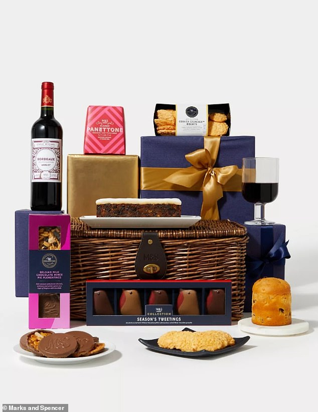 Eat, drink and be merry with M&S' classic Christmas wicker hamper, filled with delicious nibbles and treats