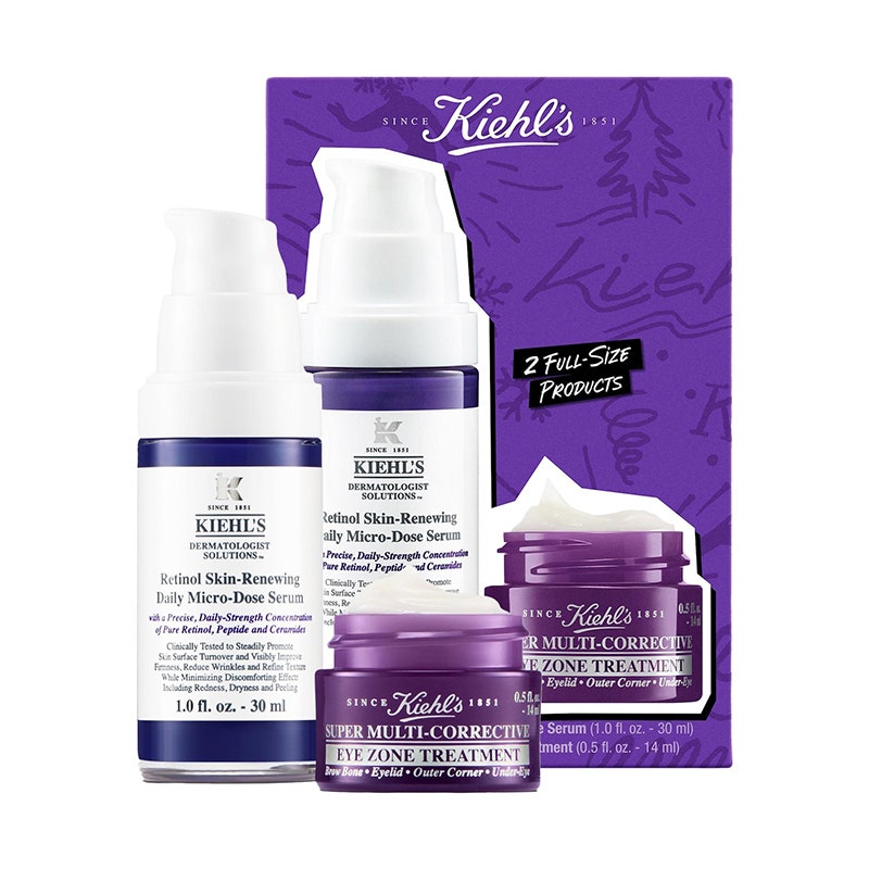Kiehl's Ultimate Anti-Aging Essentials: Ein lila Glas und eine weiß-lila Pumpflasche neben einer lila Verpackung auf weißem Hintergrund