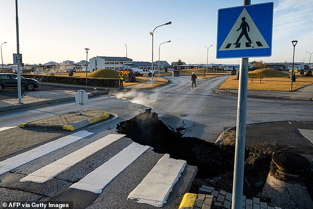 A crack cuts across the main road in Grindavik, southwestern Iceland, which has now been fully evacuated