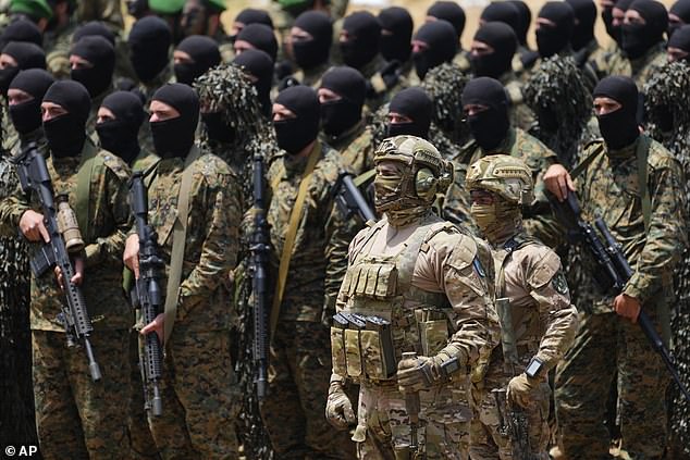 Fears are growing today that Hezbollah is set to declare war with Israel and light the touch paper for a larger conflict in the Middle East. Pictured: Hezbollah fighters carry out a training exercise in Aaramta village in the Jezzine District, southern Lebanon, Sunday, May 21, 2023