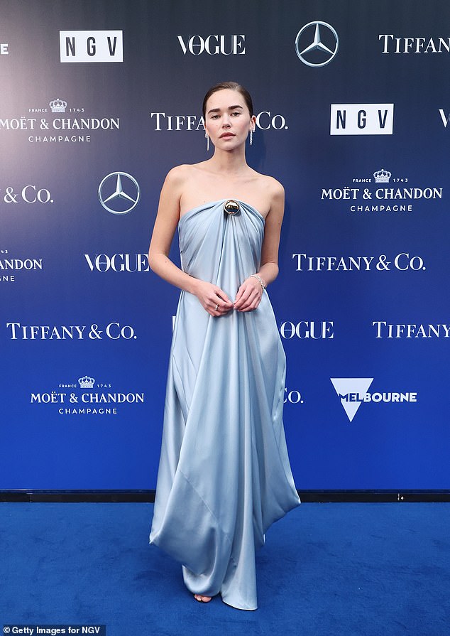 Gabriella looked chic in a blue satin gown which was casually draped around her slender frame
