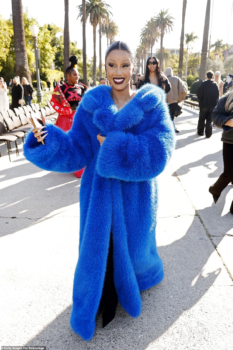 Rapper Cardi B, 31, was a vision in an opulent bight blue fur coat and later walked the Balenciaga runway