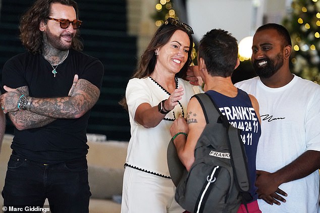 He looked in high spirits as he jumped out of the car and was greeted by the likes of Sam Thompson's best friend Pete Wicks (left) and Nick Pickard's girlfriend Sarah (centre)