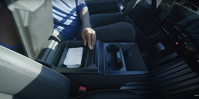 The center console includes two cupholders, two wireless charging pads, a USB-C charging port, and a 12-volt outlet