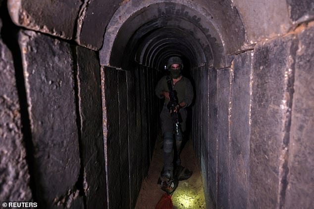 An Israeli soldier walks through a tunnel underneath Al Shifa Hospital in Gaza City on November 22