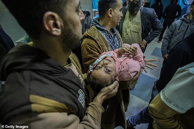 A Palestinian child, injured in an Israeli airstrike arrives at Nasser Medical Hospital on Wednesday in Khan Younis