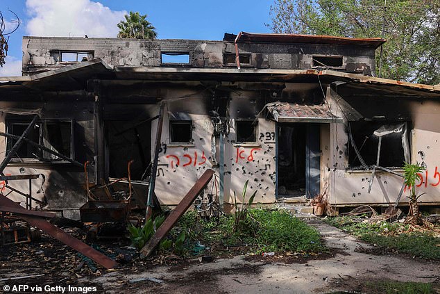 A picture shows bullet-riddled buildings damaged during the October 7 attack by Hamas terrorists in Kibbutz Kissufim in southern Israel on November 20