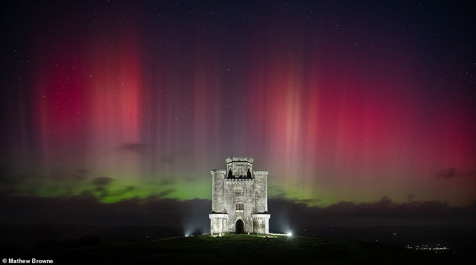 This image is a rarity, as it shows the Northern Lights in South Wales forming a spectacular backdrop to Paxton's Tower, a 200-year-old hilltop folly in the picturesque Carmarthenshire countryside. The photographer, Mathew Browne, said: 'For a brief yet magical moment, the sky came alive with impressive pink pillars, visible to the naked eye'