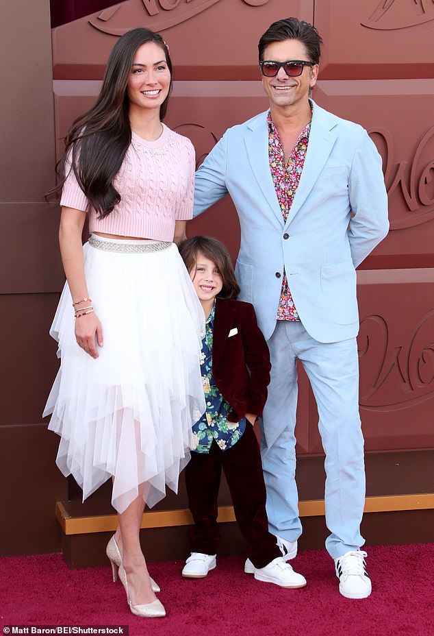 Billy — who will turn six in April — looked like a red carpet pro as he posed in between his mom and dad