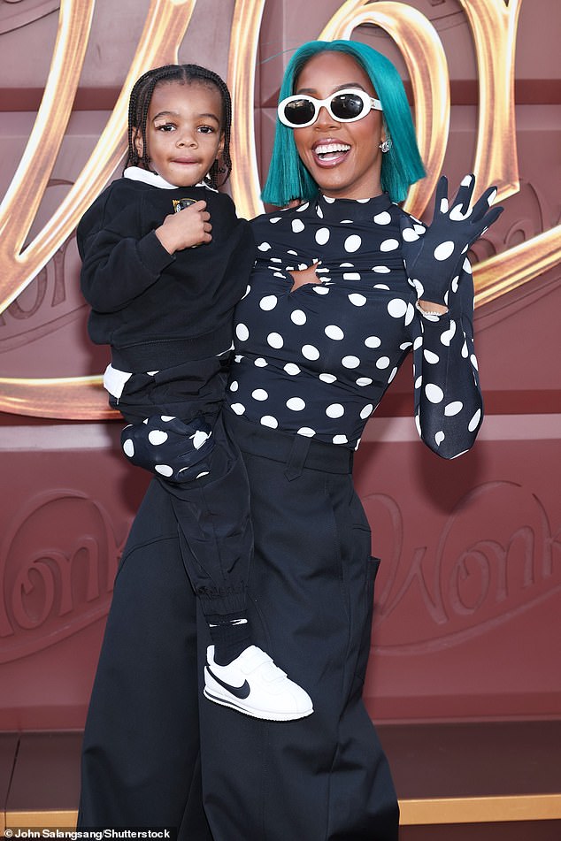 Kelly Rowland caught the eye in a cropped turquoise wig as she arrived to the event with her two-year-old son Noah in her arms