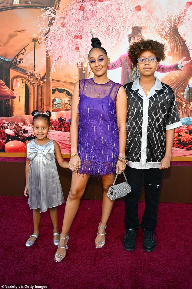 Tia Mowry looked pretty in a sheer purple frock as she arrived at the premiere with her son Cree, 12, and daughter Cairo, five