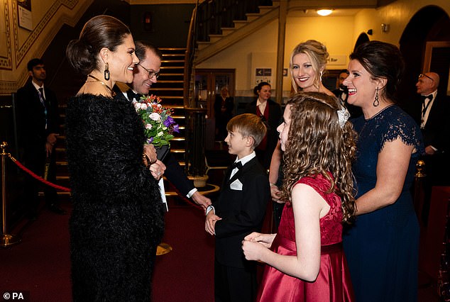 Crown Princess Victoria of Sweden also gracefully accepted a posy of flowers as she arrived at the performance