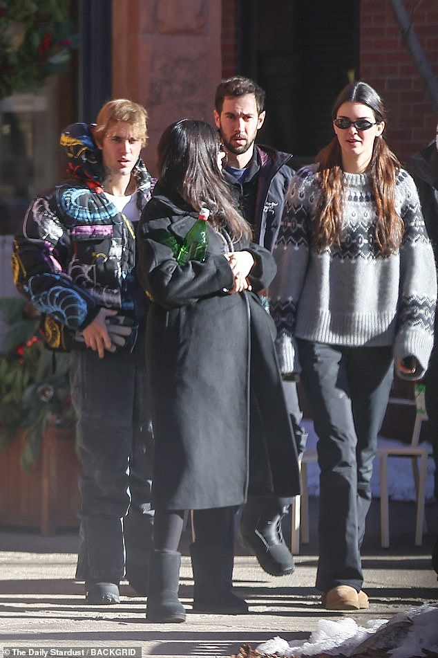 Kendall walked alongside Justin and friends, with everyone bundled up in warm clothing to brave the chilly winter weather