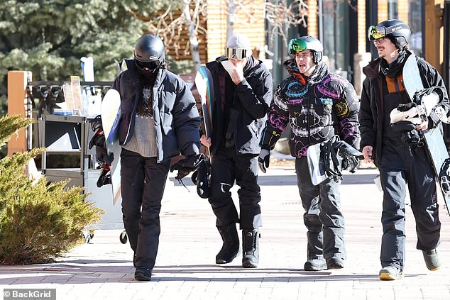 After getting dressed up the friends were pictured walking with their snowboarding gear