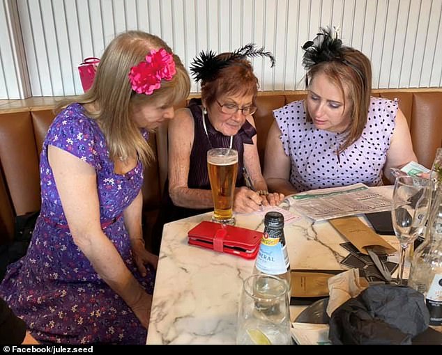 The images show Ms Seed (right) happy and smiling, wearing a pink dress with black polka dots and a black fascinator as she studies the form guides ahead of the race at a local bar