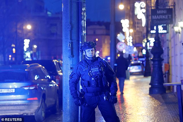 A police officer secures the area following the shooting at one of the buildings of Charles University in Prague