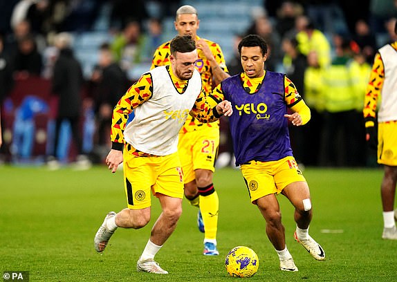 Sheffield United's Cameron Archer and Jack Robinson warming up prior to kick-off before the Premier League match at Villa Park, Birmingham. Picture date: Friday December 22, 2023. PA Photo. See PA story SOCCER Villa. Photo credit should read: Nick Potts/PA Wire.RESTRICTIONS: EDITORIAL USE ONLY No use with unauthorised audio, video, data, fixture lists, club/league logos or "live" services. Online in-match use limited to 120 images, no video emulation. No use in betting, games or single club/league/player publications.