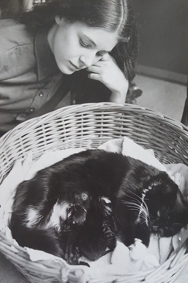 Seeing the film complete for the first time was like stepping back 50 years, says Tacy. Pictured with a cat and her kittens when she was younger