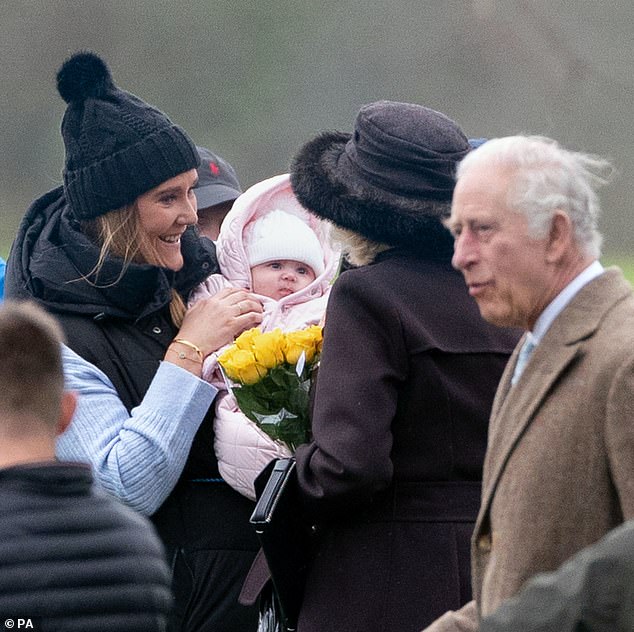 Queen Camilla meets an adorable looking baby amongst the crowds gathered at Sandringham on Christmas Eve
