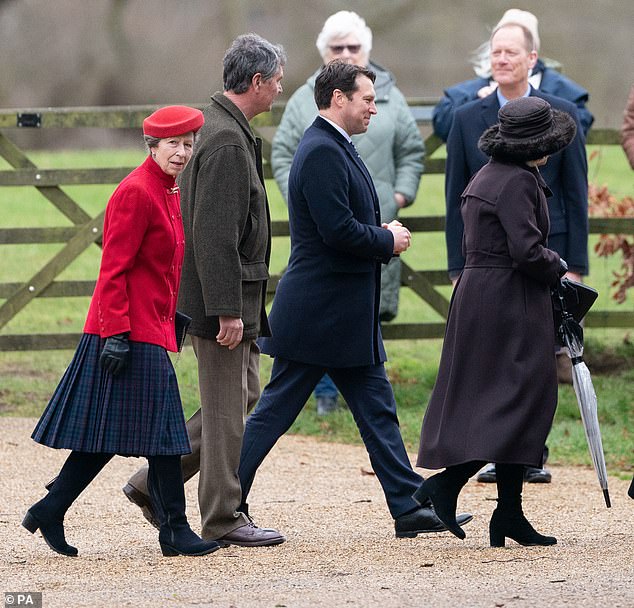 Princess Anne, in a red and tartan ensemble, looks back at gathered well-wishers as the family make their way into the service