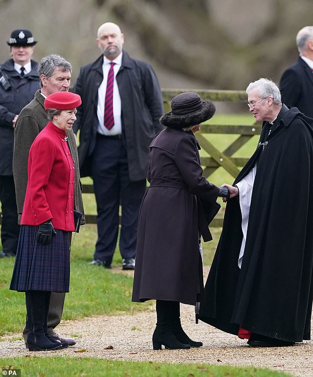 Queen Camilla shakes the hand of Reverend Canon Dr Paul Williams as she arrives, with Princess Anne and Sir Tim Laurence looking on