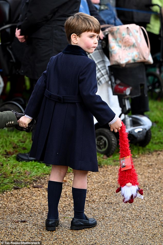 One fan gave Prince Louis a feathered Santa toy last year, which he carried with him (pictured)