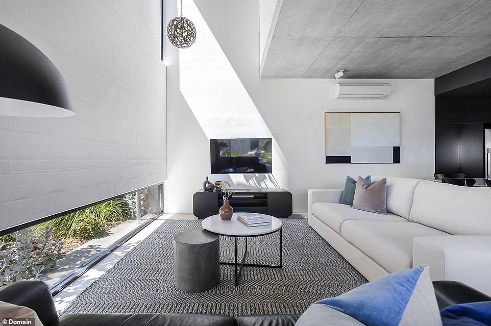 A low lying window in the lounge allows for light to come into the lounge will offering privacy from the street while a soaring double-height void provides a sense of grandeur