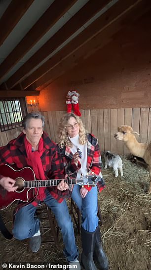 The pair sported matching jeans and red denim jackets as they sang about a 'Goat' Christmas as they harmonized in a barn with their farm animals