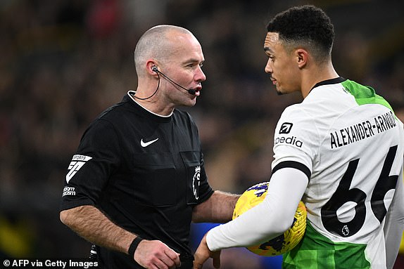 English referee Paul Tierney (L) speaks with Liverpool's English defender #66 Trent Alexander-Arnold (R) during the English Premier League football match between Burnley and Liverpool at Turf Moor in Burnley, north-west England on December 26, 2023. (Photo by Paul ELLIS / AFP) / RESTRICTED TO EDITORIAL USE. No use with unauthorized audio, video, data, fixture lists, club/league logos or 'live' services. Online in-match use limited to 120 images. An additional 40 images may be used in extra time. No video emulation. Social media in-match use limited to 120 images. An additional 40 images may be used in extra time. No use in betting publications, games or single club/league/player publications. /  (Photo by PAUL ELLIS/AFP via Getty Images)