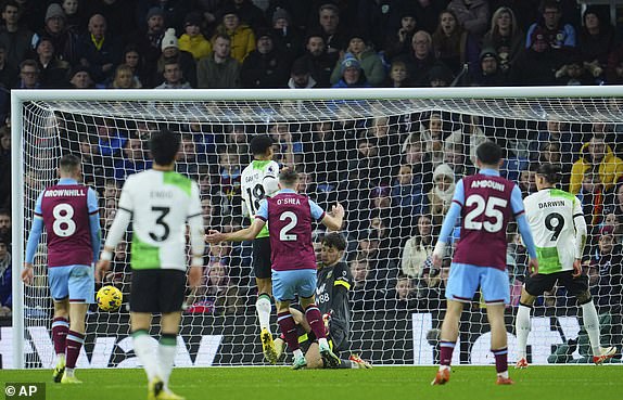 Liverpool's Cody Gakpo, center left, takes a shot on goal during the English Premier League soccer match between Burnley and Liverpool at Turf Moor stadium in Burnley, England, Tuesday, Dec. 26, 2023. (AP Photo/Jon Super)
