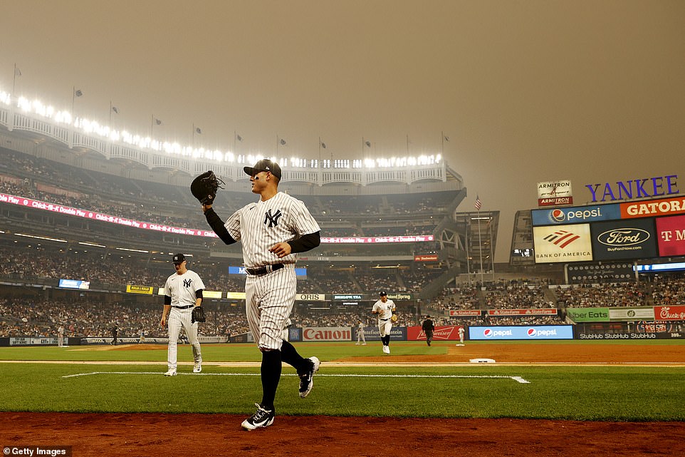 General view of hazy conditions resulting from Canadian wildfires as Anthony Rizzo of the New York Yankees jogs to the dugout during the second inning against the Chicago White Sox at Yankee Stadium on June 6, 2023 in the Bronx