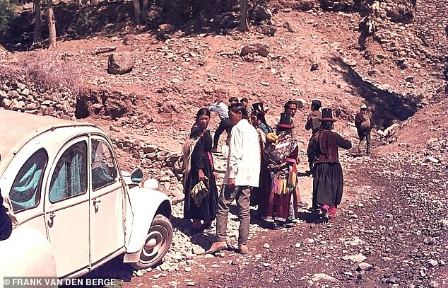 Ladakh locals looking at Frank's second-hand 2CV4 in 1976. Throughout his road trip, Frank mostly slept in his car, creating a 'simple bed' using his small suitcase, an Afghan coat and an old sleeping bag