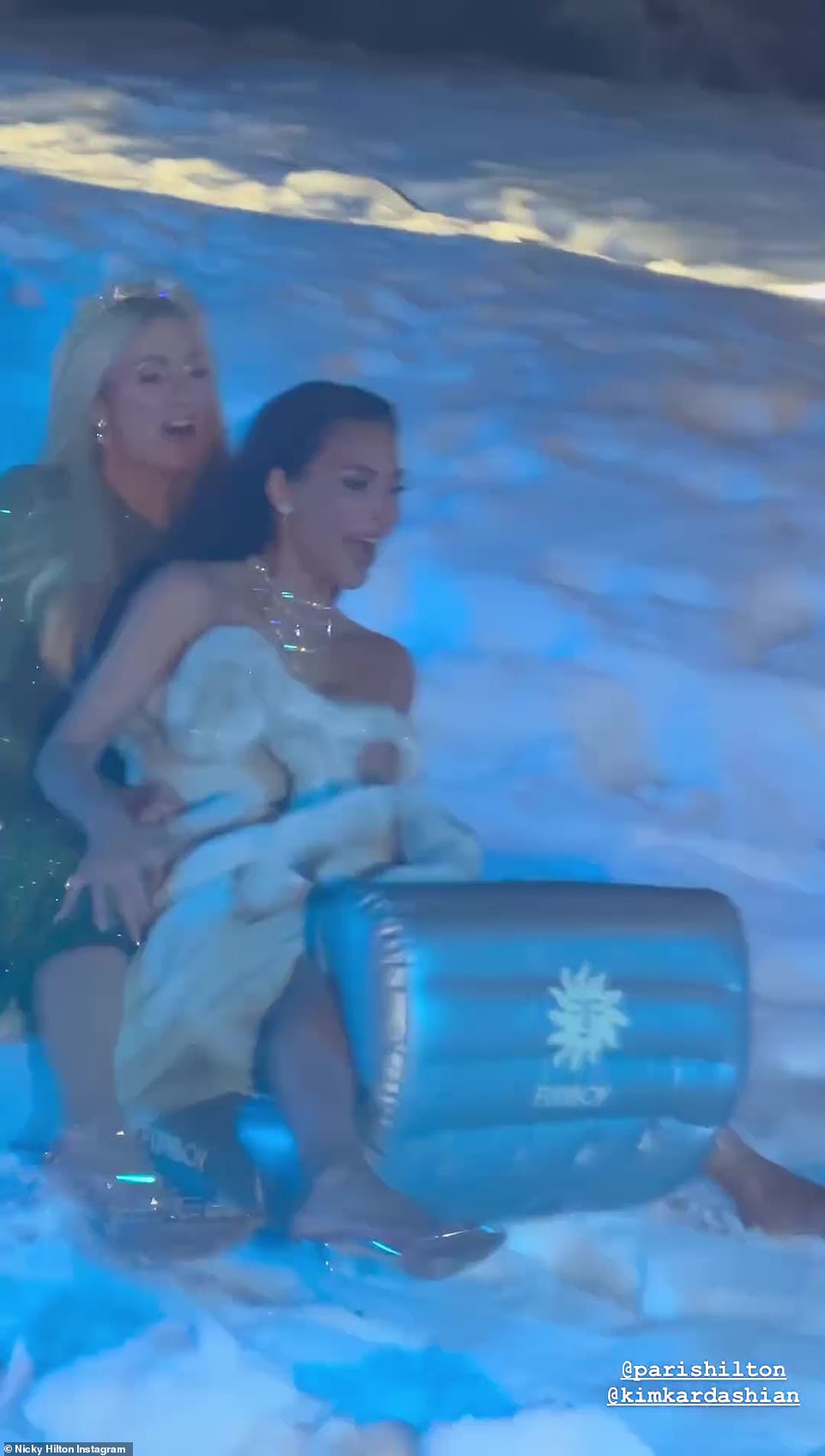 Kim Kardashian and Paris Hilton rode a sled over tons of fake snow at the annual Kardashian-Jenner Christmas Eve party on Sunday evening