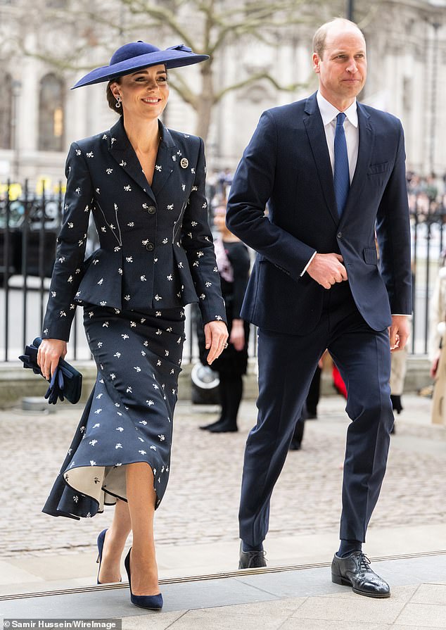 Kate teamed the tailored suit navy Gianvito Rossi pumps, an Emmy London clutch, a matching Sean Barrett hat and jewellery passed down by the Royal Family