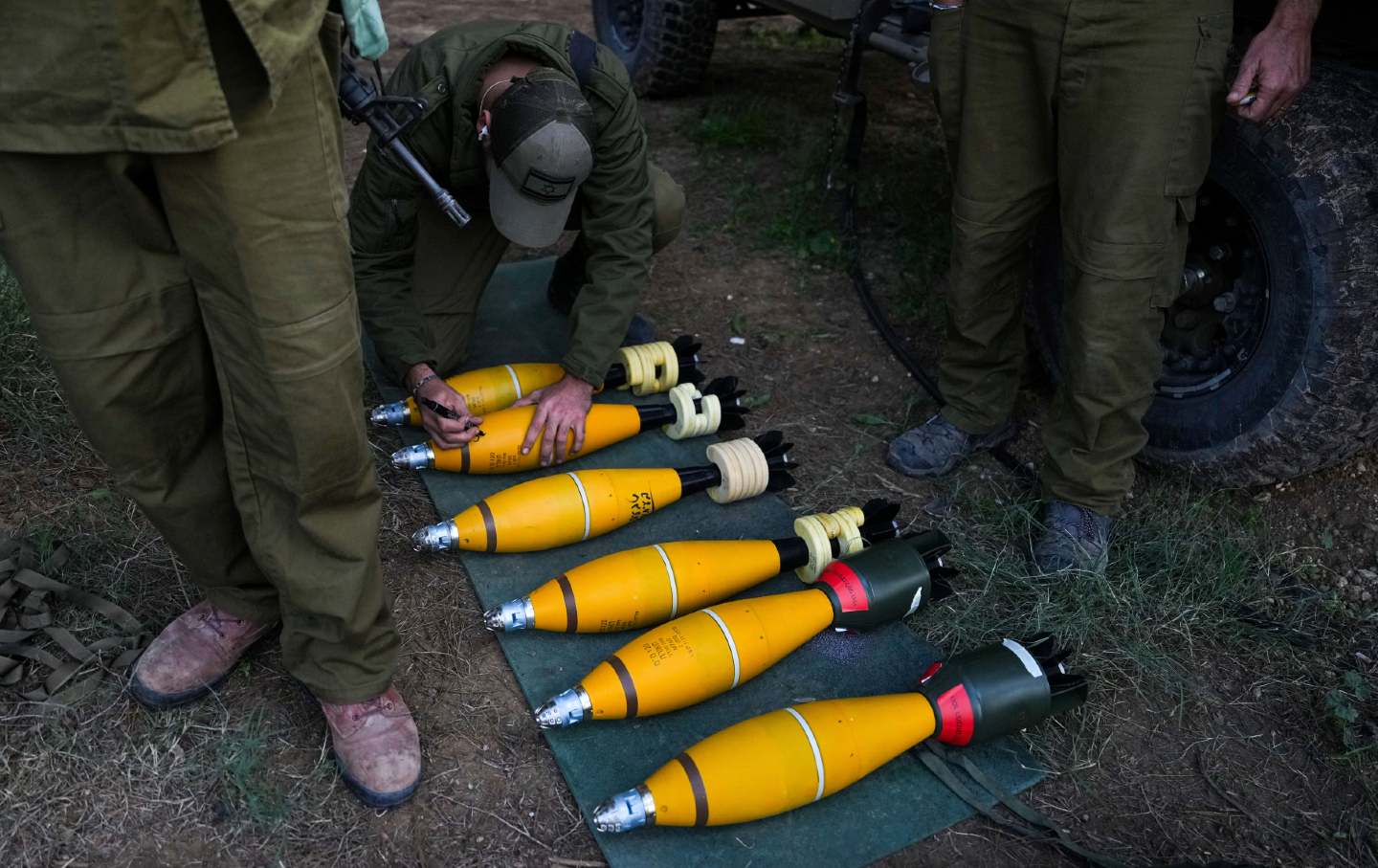 An Israeli soldier writes on a mortar near the Israel-Gaza border on December 20, 2023.