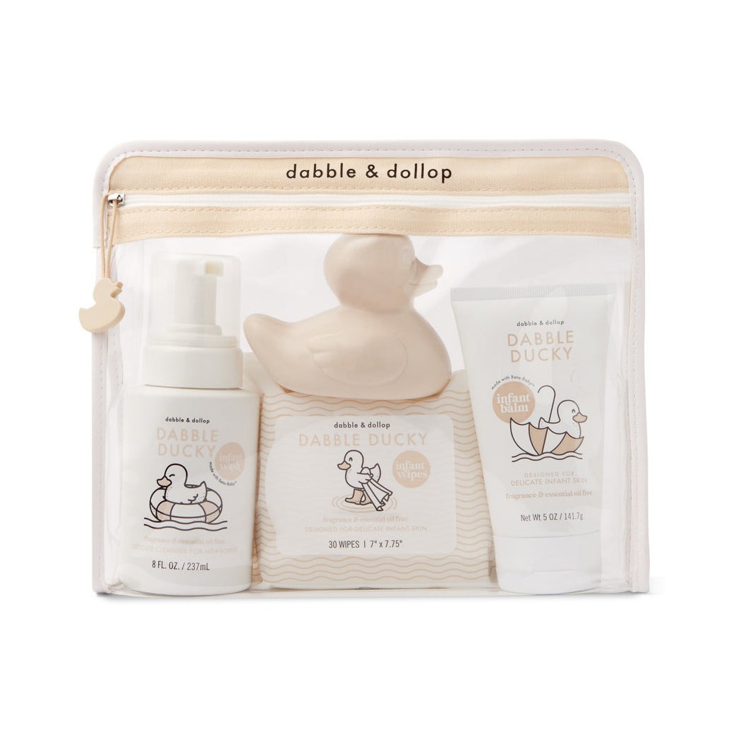 Dabble & Dollop Willkommens-Baby-Geschenkset, transparente Tüte mit Flaschen Baby-Shampoo, Lotion und beigem Quietscheentchen auf weißem Hintergrund