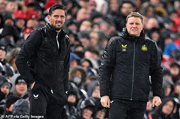Newcastle United's English head coach Eddie Howe (R) and Newcastle United's assistant coach Jason Tindall (L) look on during the English Premier League football match between Liverpool and Newcastle United at Anfield in Liverpool, north west England on January 1, 2024. (Photo by PETER POWELL / AFP) / RESTRICTED TO EDITORIAL USE. No use with unauthorized audio, video, data, fixture lists, club/league logos or 'live' services. Online in-match use limited to 120 images. An additional 40 images may be used in extra time. No video emulation. Social media in-match use limited to 120 images. An additional 40 images may be used in extra time. No use in betting publications, games or single club/league/player publications. /  (Photo by PETER POWELL/AFP via Getty Images)