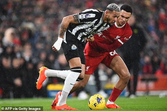 Newcastle United's Brazilian striker #07 Joelinton (L) vies with Liverpool's English defender #66 Trent Alexander-Arnold (R) during the English Premier League football match between Liverpool and Newcastle United at Anfield in Liverpool, north west England on January 1, 2024. (Photo by PETER POWELL / AFP) / RESTRICTED TO EDITORIAL USE. No use with unauthorized audio, video, data, fixture lists, club/league logos or 'live' services. Online in-match use limited to 120 images. An additional 40 images may be used in extra time. No video emulation. Social media in-match use limited to 120 images. An additional 40 images may be used in extra time. No use in betting publications, games or single club/league/player publications. /  (Photo by PETER POWELL/AFP via Getty Images)