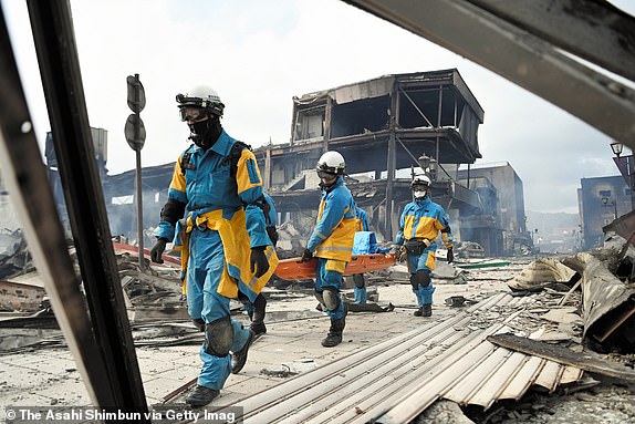 WAJIMA, JAPAN - JANUARY 02: Police officers search for survivors at the Asaichi Yokocho district where approximately 200 buildings have been burnt down after multiple strong earthquakes the previous day on January 2, 2024 in Wajima, Ishikawa, Japan. A tsunami warning was issued Japan's coastline after a series of earthquakes, the biggest measuring 7.6 magnitude, hit the areas around Toyama and Niigata in central Japan. At least 30 people confirmed dead in Ishikawa Prefecture, where is the epicenter of the earthquakes. (Photo by The Asahi Shimbun via Getty Images)